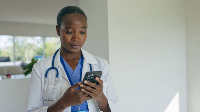 image of a nurse using ai on her phone