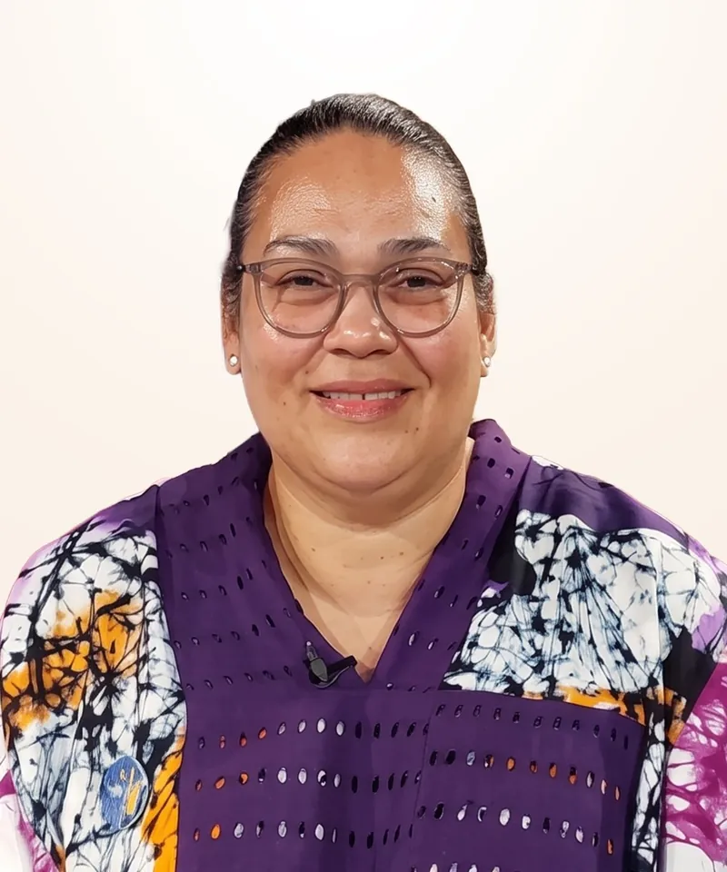 Dr. Denise Uzoma Ejoh, PhD, smiling, wearing glasses and a patterned top